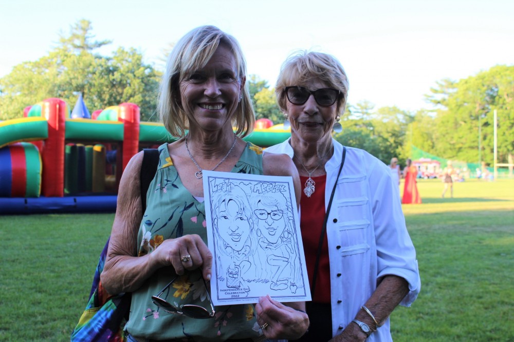Posing with their Caricature picture that was done at Canton Parks on 6/26/22!