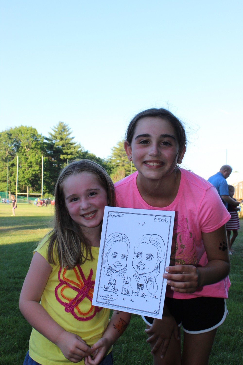 Kendall and Brooke smiling with their Caricature picture at Canton Parks on 6/26/22!