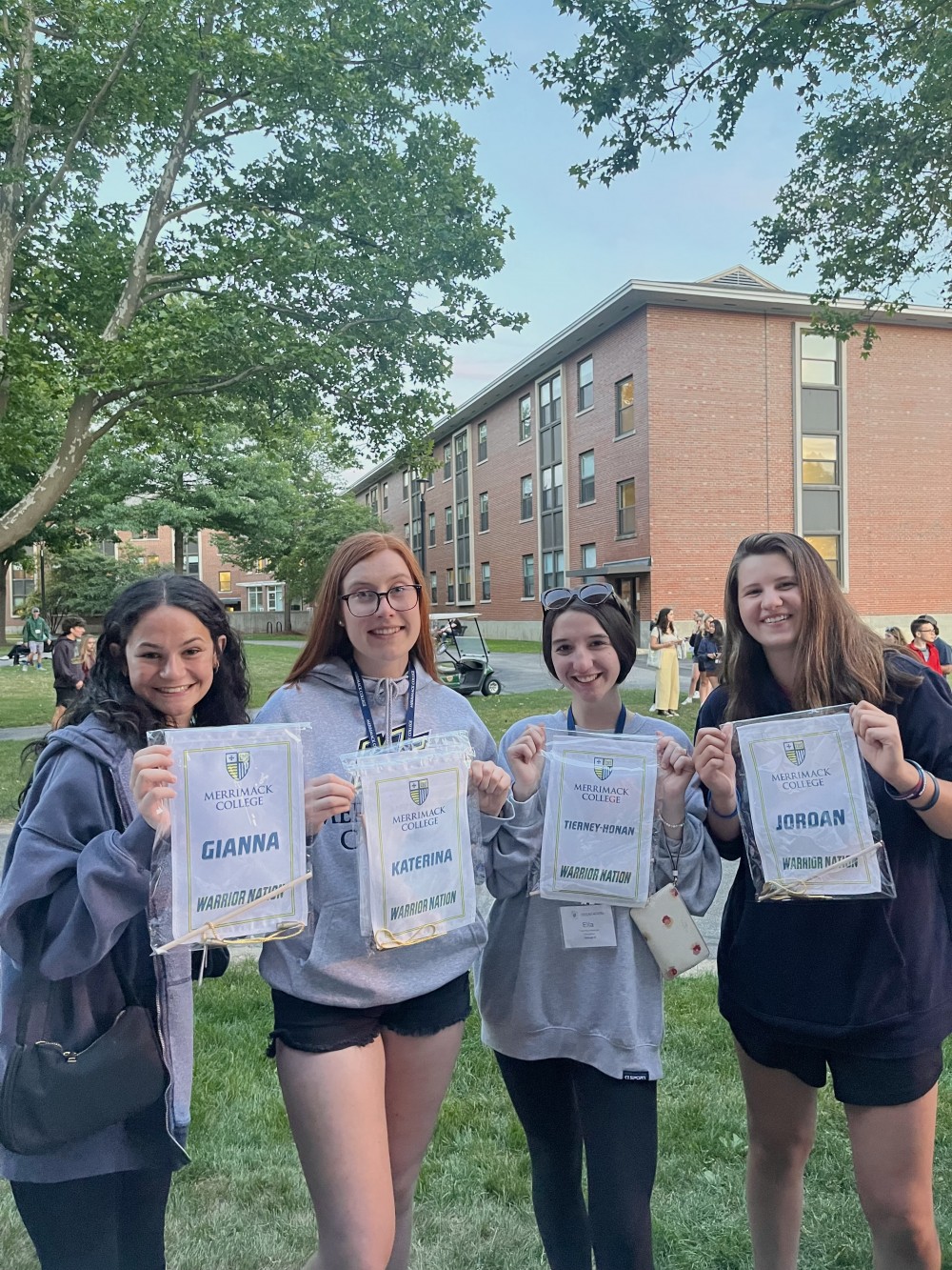 Gianna, Katerina, Ella, and Jordan with their personalized banners at Merrimack College orientation on 6/20/22!